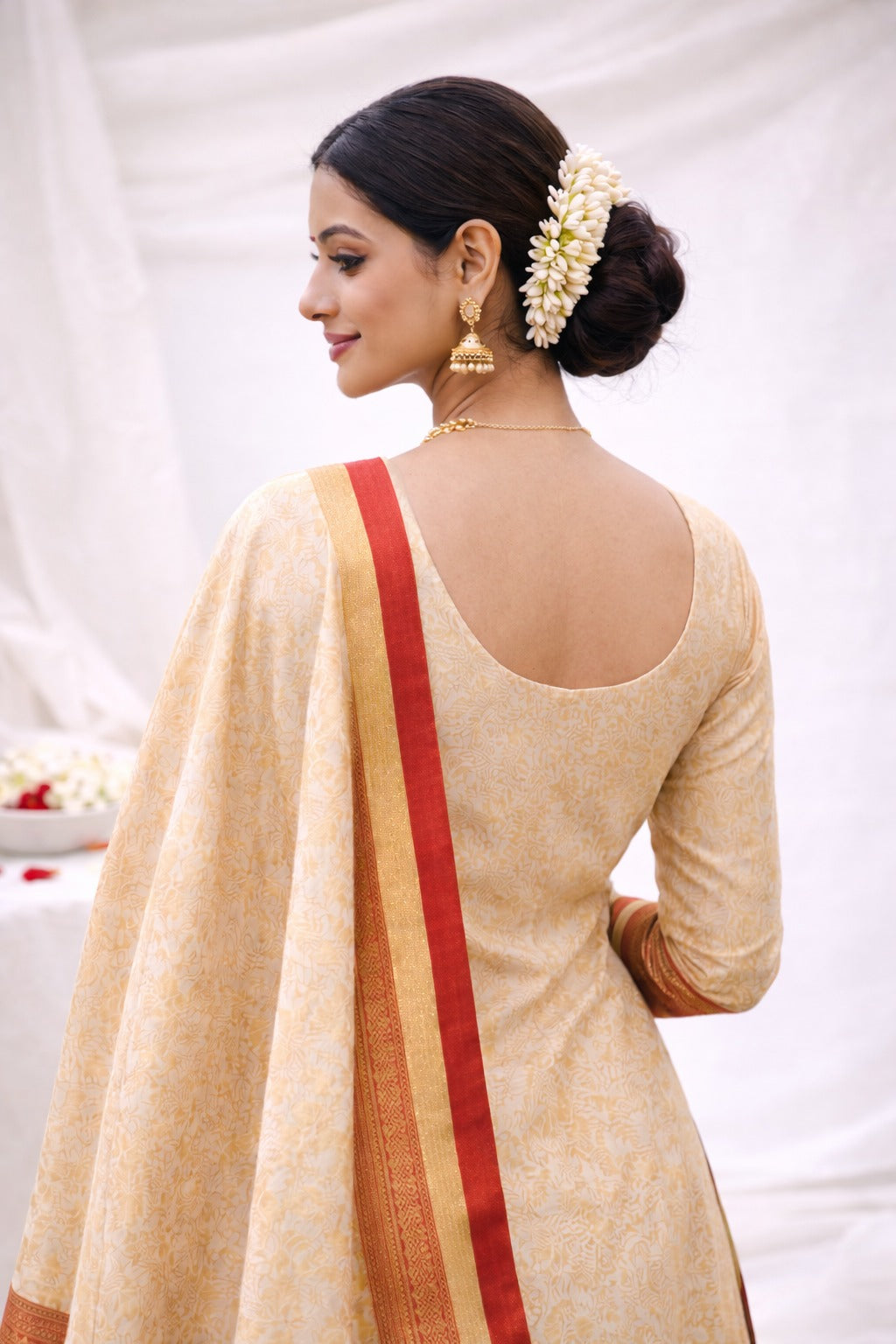 Golden beige kurta material with red border. Back pose giving idea how you should style
