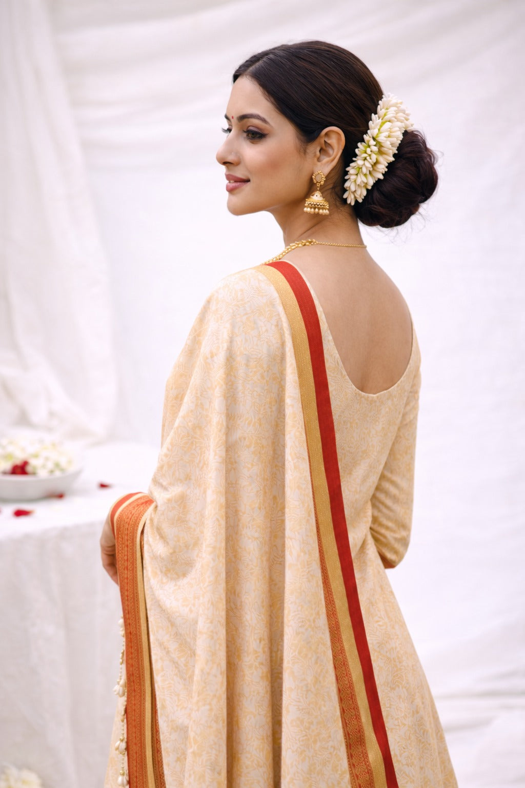 Golden beige kurta material with red border. Style guide from the side perspective