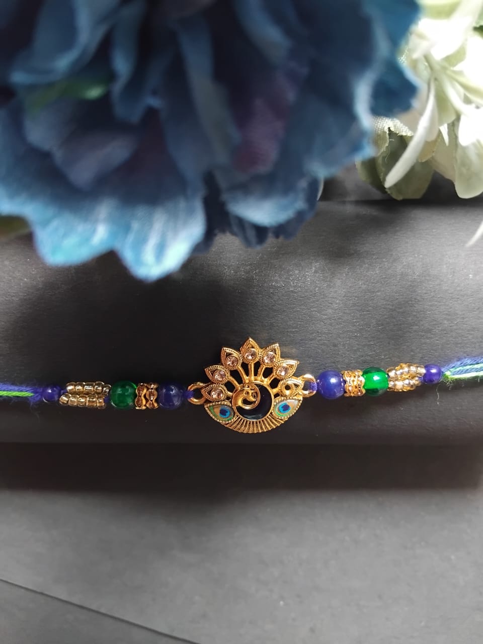 Golden-Black Rakhi Set BUTTON CRYP – with Free Roli Chawal, Chocolate and Greeting Card